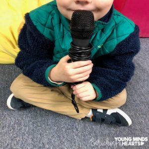 A picture of a student holding a microphone as he is sharing with the class